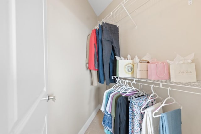 walk in closet with carpet flooring