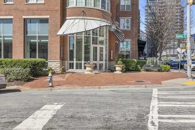 property entrance featuring stone siding and brick siding