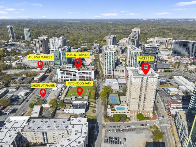 view of property location with a forest and nearby urban area