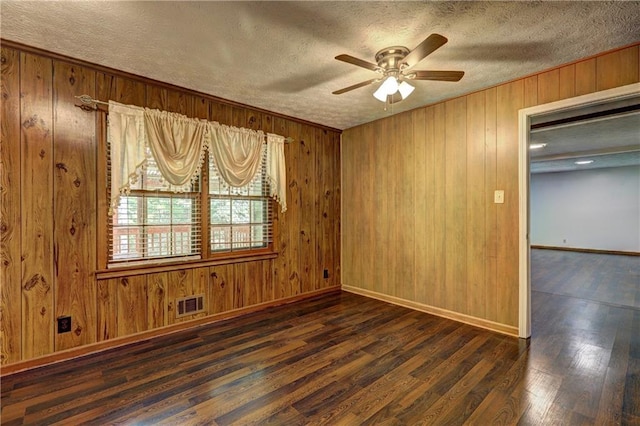 empty room featuring ceiling fan, a textured ceiling, and visible vents