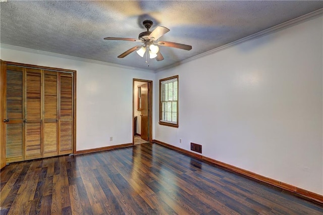 unfurnished bedroom featuring baseboards, wood finished floors, a textured ceiling, and ornamental molding