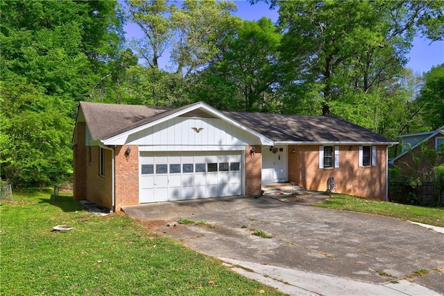view of front of home with brick siding, a front lawn, driveway, and a garage