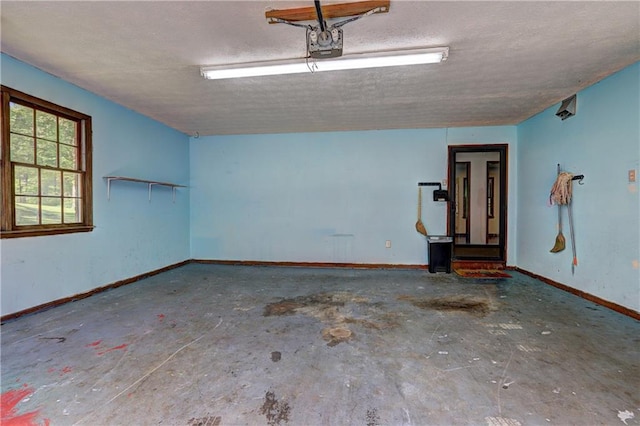 garage with baseboards and a garage door opener