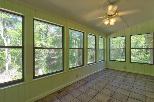 unfurnished sunroom featuring vaulted ceiling and visible vents