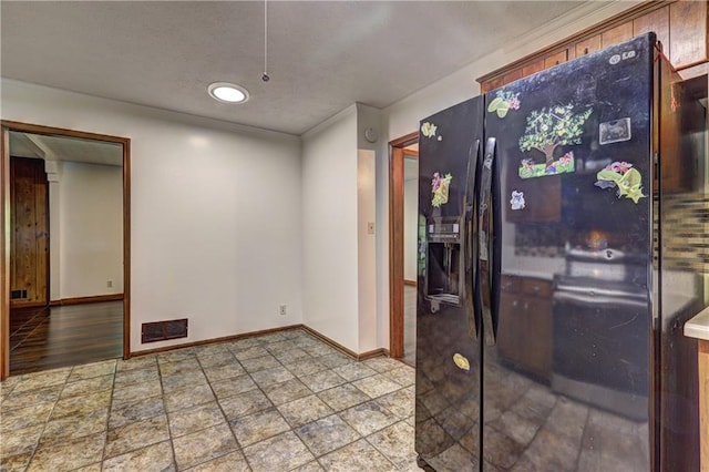 interior space featuring stone finish flooring, baseboards, a textured ceiling, and visible vents