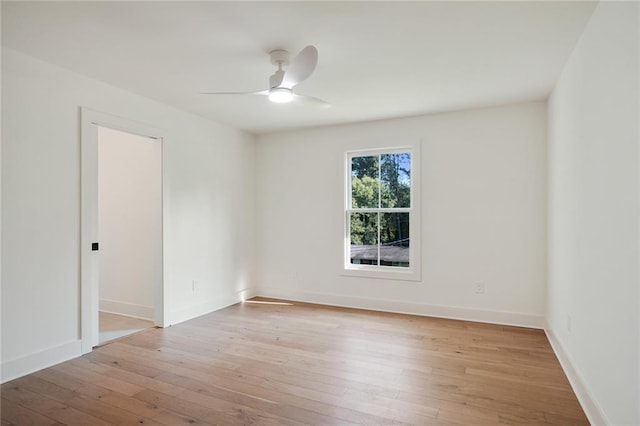 empty room with ceiling fan and light wood-type flooring