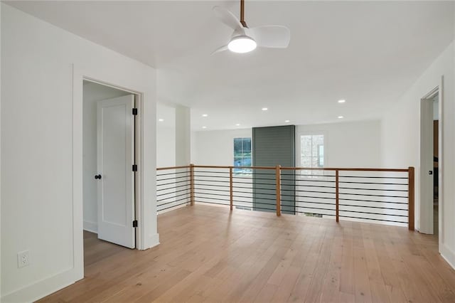 spare room featuring ceiling fan and light wood-type flooring