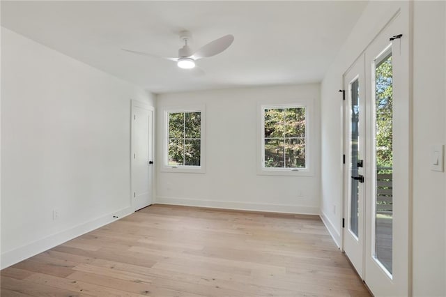 spare room with ceiling fan and light wood-type flooring