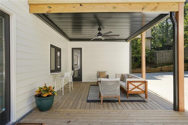 wooden deck with ceiling fan and an outdoor hangout area