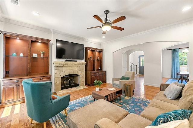 2317 Whiting Bay Cts NW, Kennesaw, GA 30152 - living area with a ceiling fan, arched walkways, light wood-style floors, a fireplace, and ornamental molding