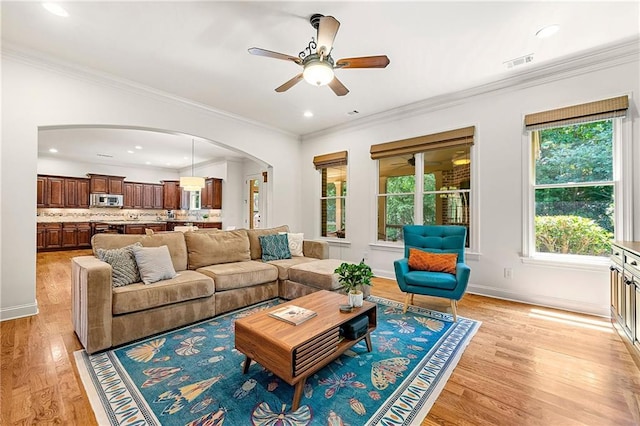 2317 Whiting Bay Cts NW, Kennesaw, GA 30152 - living area featuring arched walkways, light wood-style floors, ceiling fan, crown molding, and recessed lighting