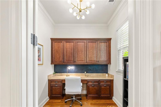 2317 Whiting Bay Cts NW, Kennesaw, GA 30152 - office featuring built in desk, wood finished floors, crown molding, and a chandelier