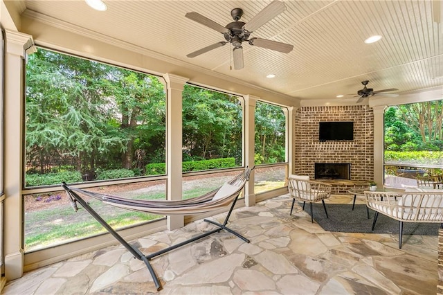 2317 Whiting Bay Cts NW, Kennesaw, GA 30152 - view of patio featuring an outdoor brick fireplace, ceiling fan, and view of wooded area
