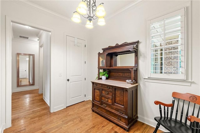 2317 Whiting Bay Cts NW, Kennesaw, GA 30152 - living area with ornamental molding, a chandelier, and light wood-style floors