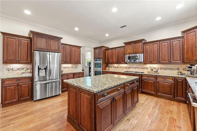 2317 Whiting Bay Cts NW, Kennesaw, GA 30152 - kitchen with stainless steel appliances, a kitchen island, decorative backsplash, recessed lighting, and crown molding