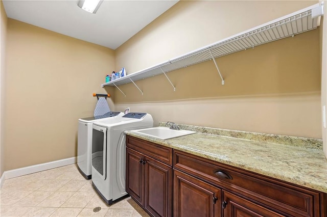2317 Whiting Bay Cts NW, Kennesaw, GA 30152 - laundry room featuring washing machine and clothes dryer, cabinet space, and light tile patterned flooring