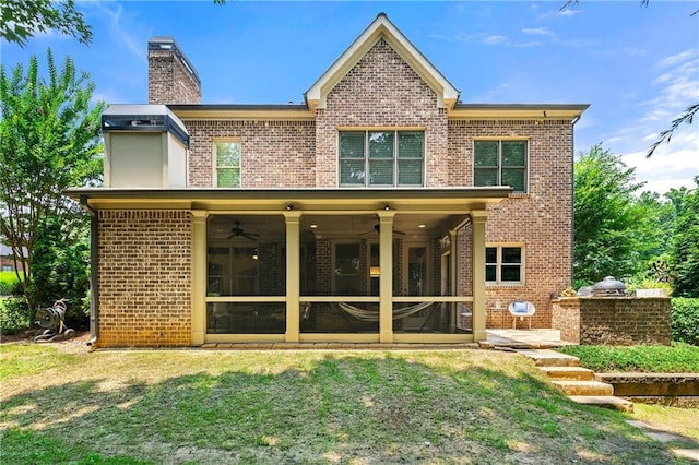 2317 Whiting Bay Cts NW, Kennesaw, GA 30152 - back of house with ceiling fan, brick siding, a chimney, a lawn, and a patio area