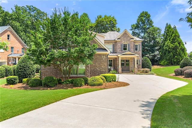 2317 Whiting Bay Cts NW, Kennesaw, GA 30152 - view of front of home with brick siding, a front lawn, driveway, and a standing seam roof