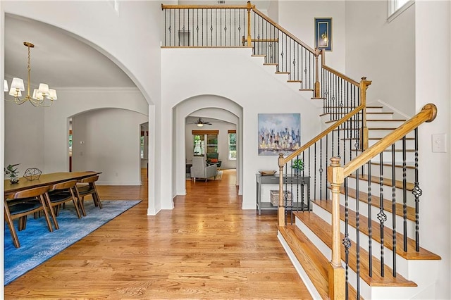 2317 Whiting Bay Cts NW, Kennesaw, GA 30152 - foyer with light wood-style flooring, arched walkways, a ceiling fan, a high ceiling, and stairway
