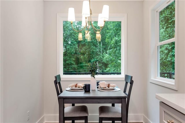 455 Sams Rd, Dawsonville, GA 30534 - dining space with a chandelier, baseboards, and healthy amount of natural light