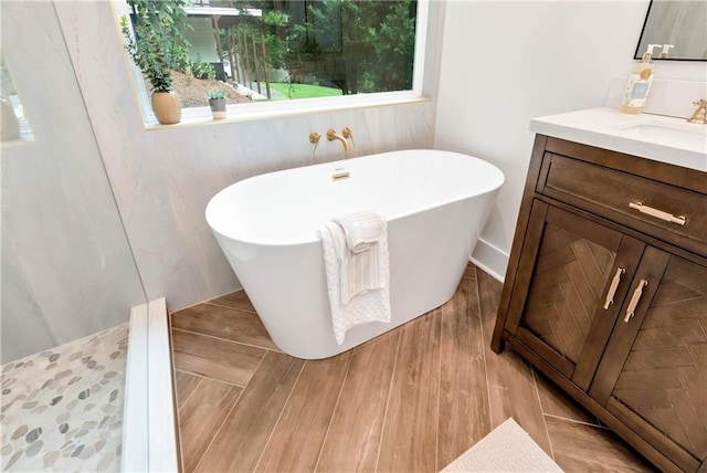 455 Sams Rd, Dawsonville, GA 30534 - full bathroom featuring vanity, a freestanding tub, and wood finished floors