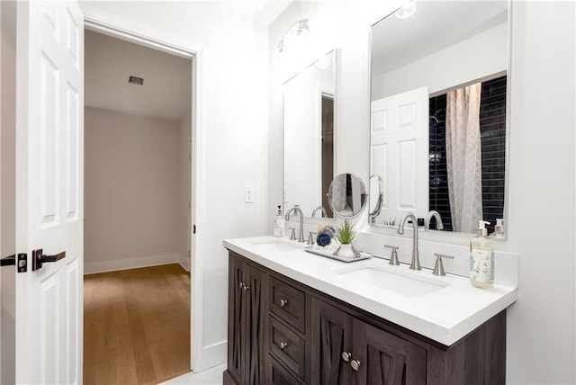 455 Sams Rd, Dawsonville, GA 30534 - full bathroom with double vanity, wood finished floors, and baseboards