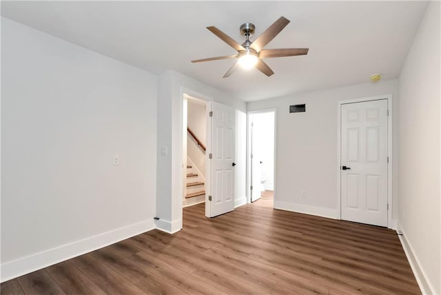 455 Sams Rd, Dawsonville, GA 30534 - unfurnished room with baseboards, ceiling fan, wood finished floors, and stairs