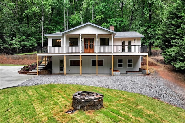 455 Sams Rd, Dawsonville, GA 30534 - view of front of property featuring french doors, an outdoor fire pit, a front lawn, and a chimney