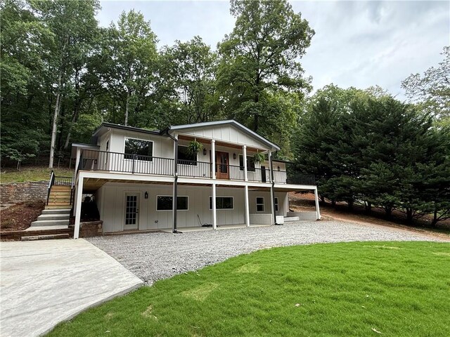 455 Sams Rd, Dawsonville, GA 30534 - back of house with a lawn, stairs, board and batten siding, a patio, and gravel driveway