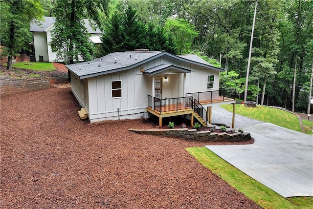455 Sams Rd, Dawsonville, GA 30534 - view of front of house featuring board and batten siding, concrete driveway, and stairs