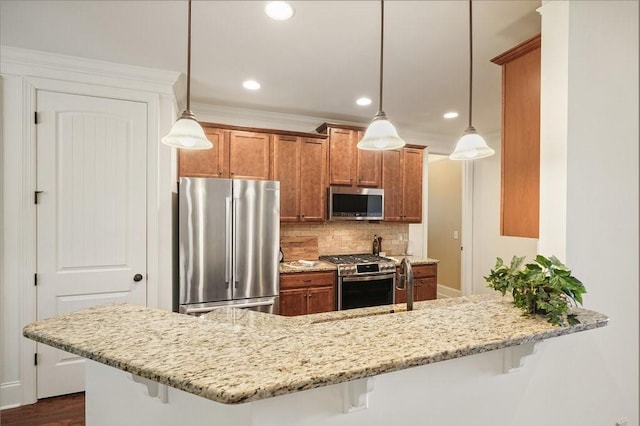 23 Durana Ct, Dallas, GA 30132 - kitchen with stainless steel appliances, brown cabinets, a kitchen breakfast bar, backsplash, and recessed lighting