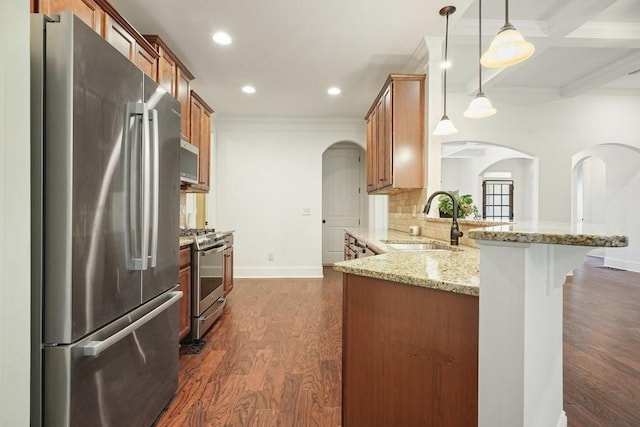 23 Durana Ct, Dallas, GA 30132 - kitchen featuring appliances with stainless steel finishes, arched walkways, a sink, crown molding, and dark wood-style flooring