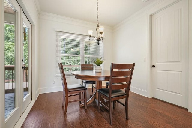 23 Durana Ct, Dallas, GA 30132 - dining area with a chandelier, dark wood finished floors, baseboards, and crown molding