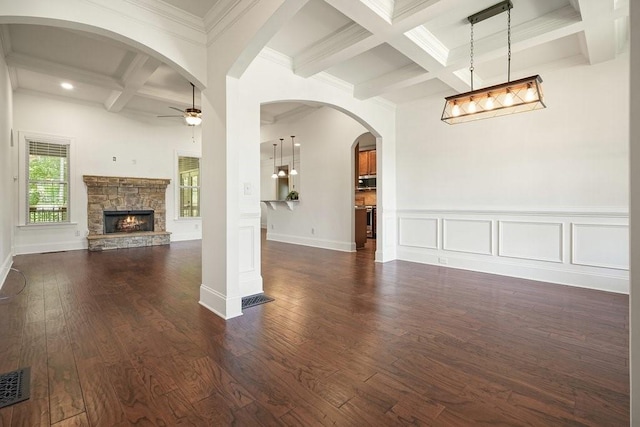 23 Durana Ct, Dallas, GA 30132 - unfurnished living room with coffered ceiling, ceiling fan, beamed ceiling, a stone fireplace, and dark wood-style floors
