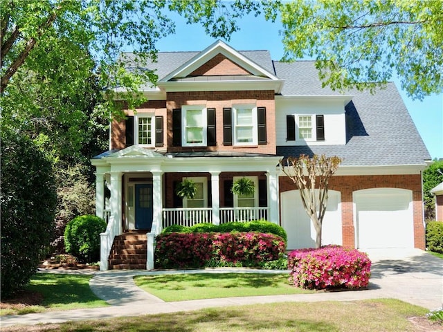 view of front facade with concrete driveway, covered porch, roof with shingles, and brick siding