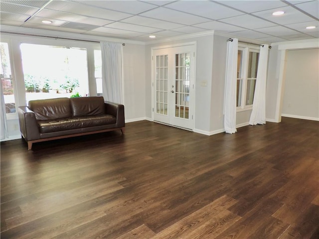 interior space with crown molding, baseboards, french doors, and wood finished floors