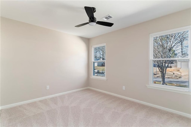 carpeted empty room featuring ceiling fan