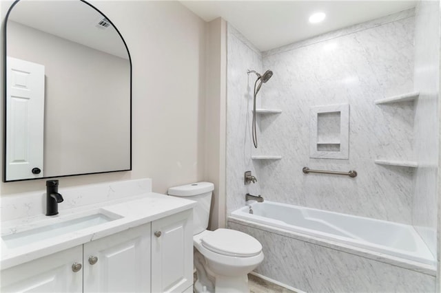 full bathroom featuring vanity, tiled shower / bath combo, and toilet