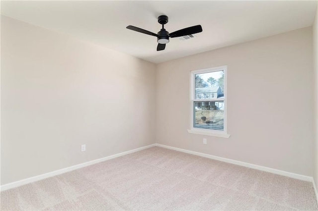 carpeted spare room featuring ceiling fan