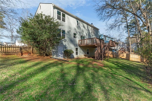 rear view of house featuring a yard and a deck