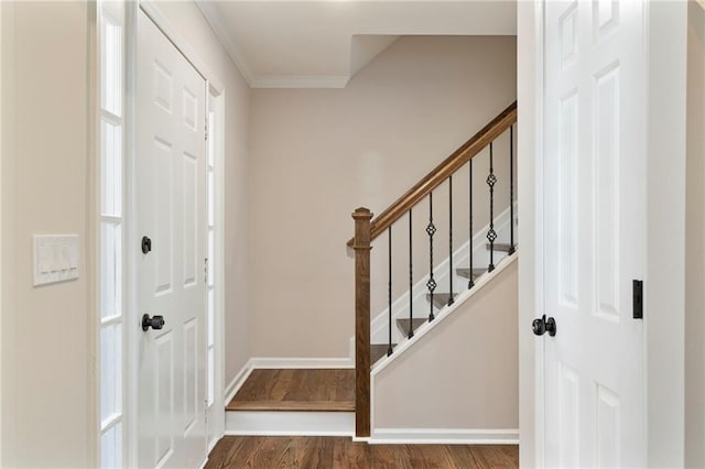 foyer entrance with hardwood / wood-style floors and ornamental molding