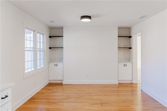 spare room featuring light hardwood / wood-style flooring