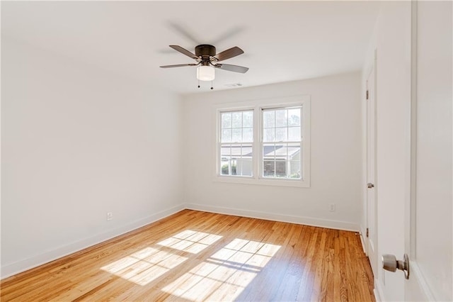 spare room with ceiling fan and light wood-type flooring