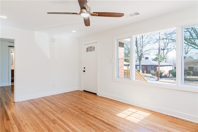 empty room with light hardwood / wood-style flooring and ceiling fan