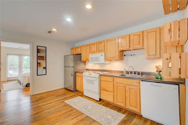 kitchen with light wood-type flooring, white appliances, sink, and light brown cabinetry