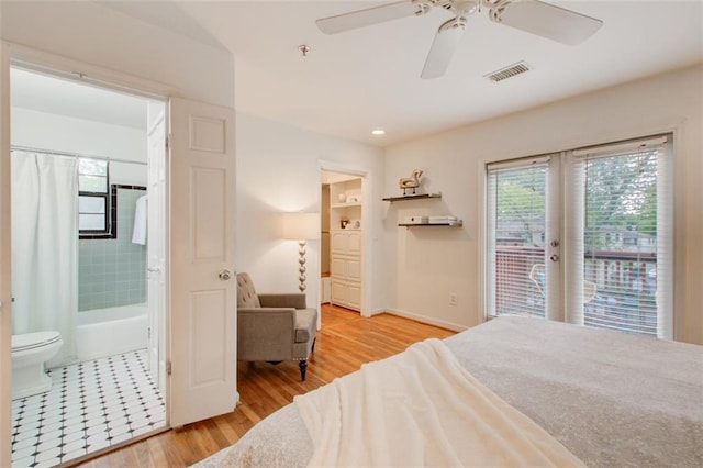 bedroom featuring connected bathroom, ceiling fan, light hardwood / wood-style floors, and access to exterior