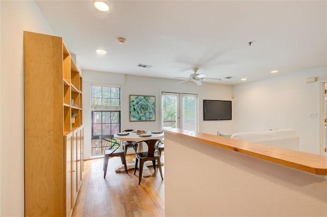 dining area featuring ceiling fan and light hardwood / wood-style floors