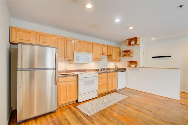 kitchen with light brown cabinets, white appliances, light hardwood / wood-style flooring, and sink