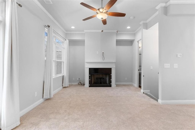 unfurnished living room featuring ceiling fan, ornamental molding, and light carpet