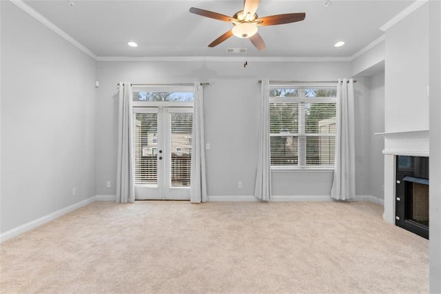 unfurnished living room featuring light carpet, crown molding, french doors, and ceiling fan